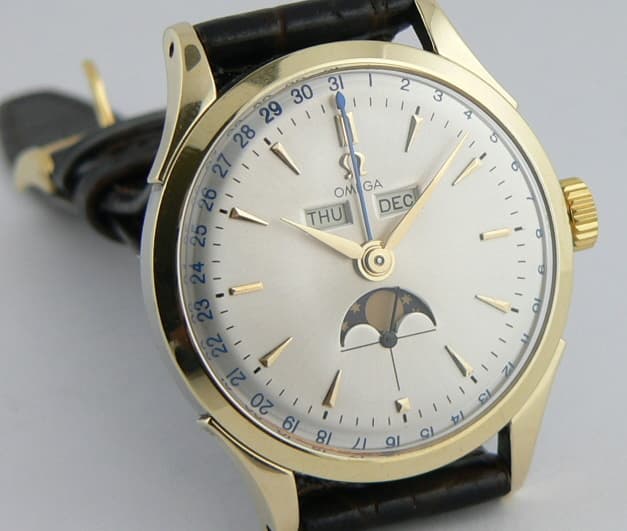 Omega Cosmic Triple date Steel and Gold Moon
English Calendar