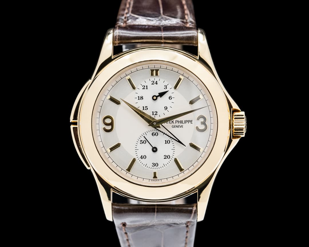 Patek Philippe Travel Time 18K Yellow Gold Manual Wind Deployant